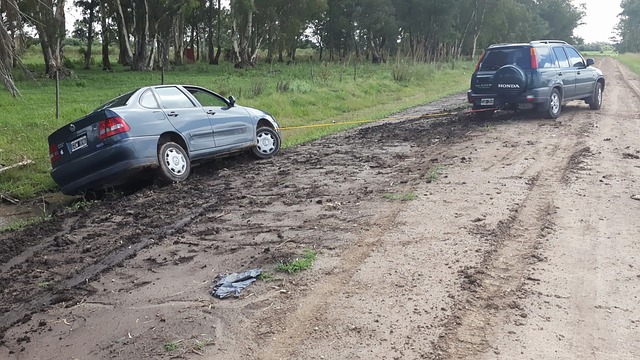 Car being pulled back on the road and sliding into a ditch